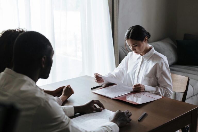 Estate planning attorney reviewing documents with a client at a desk