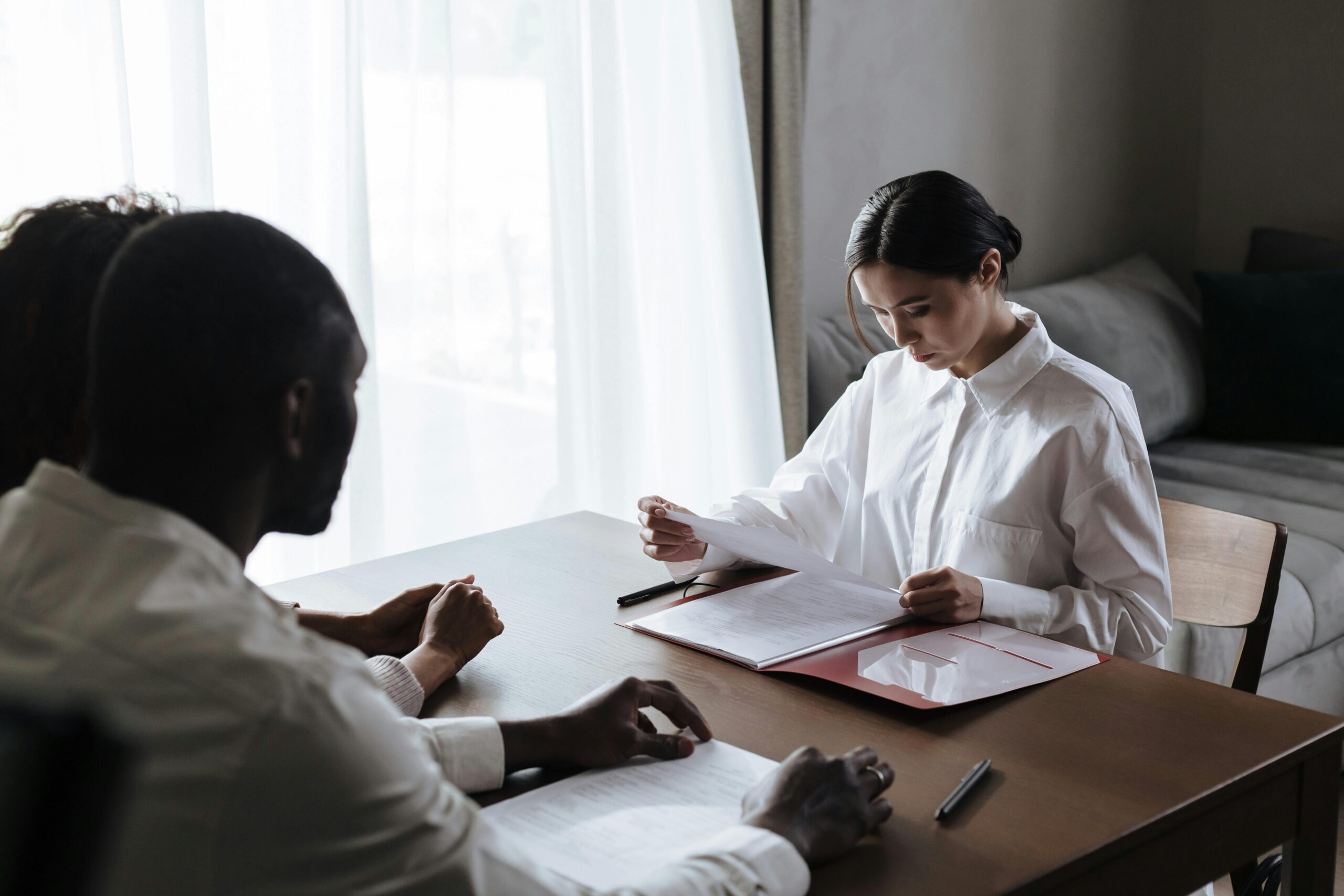 Estate planning attorney reviewing documents with a client at a desk